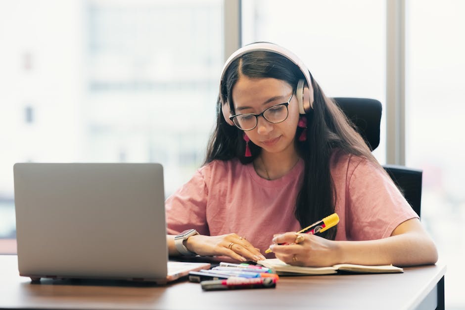 Student taking notes while listening actively